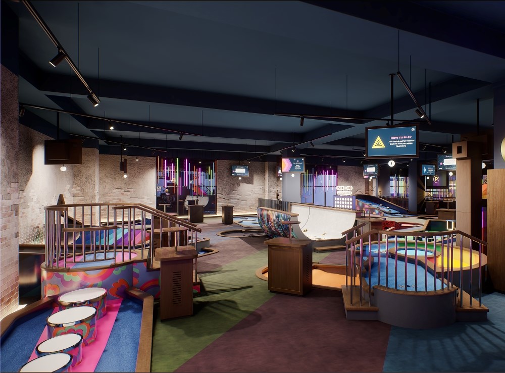 a colorful indoor miniature golf course with ramps and railings