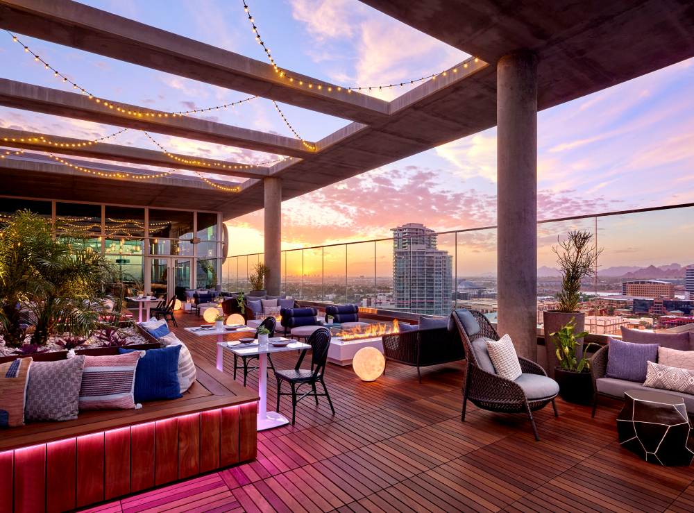 rooftop restaurant and lounge with open skylights and a sunset view of Tempe Arizona