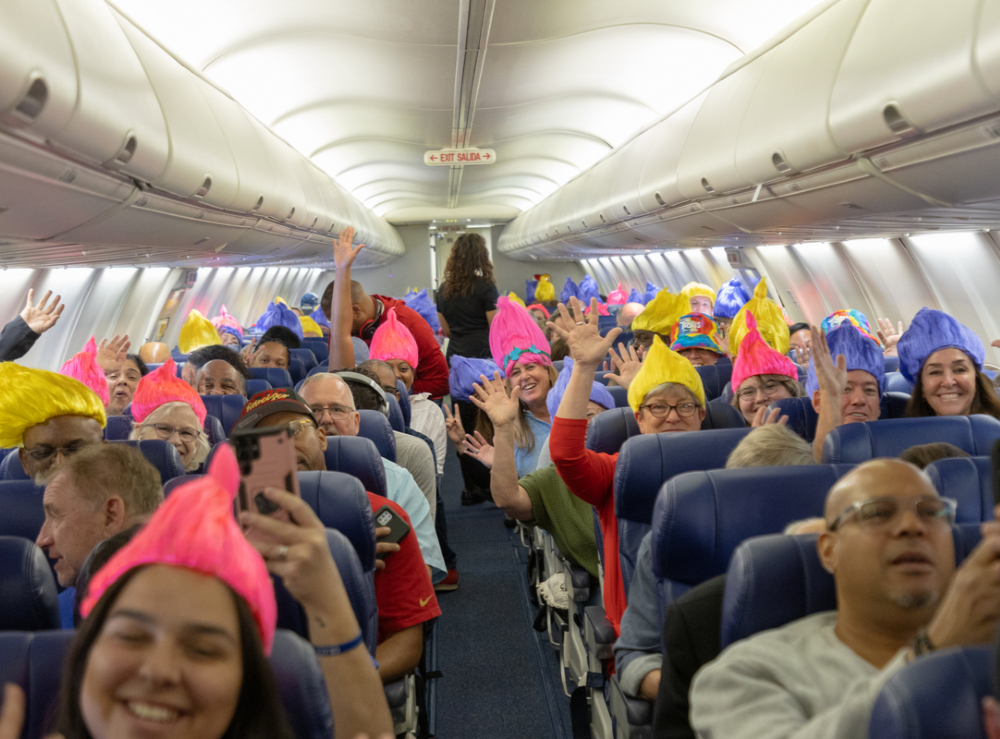 passengers aboard a Southwest Airlines aircraft with Trolls-themed hats