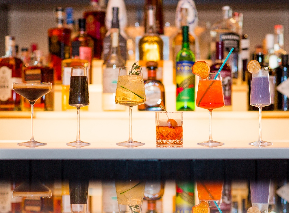 A row of different drinks and cocktails on the bar at The Elliott Bar on Pine. July 8, 2024