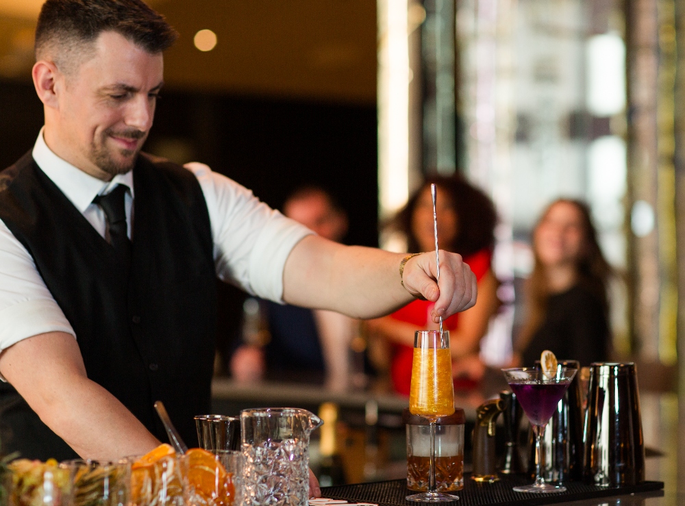 Bartender crafting a cocktail at The Elliott Bar on Pine. July 8, 2024