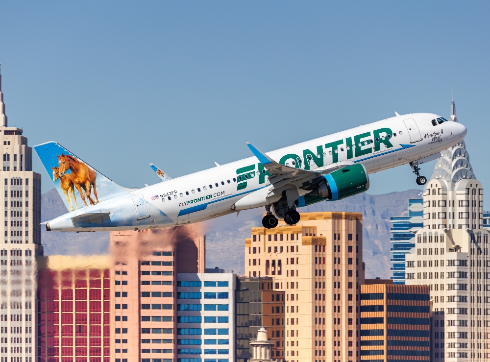 Frontier Airlines plane flying over Las Vegas, Nevada. March 7, 2025