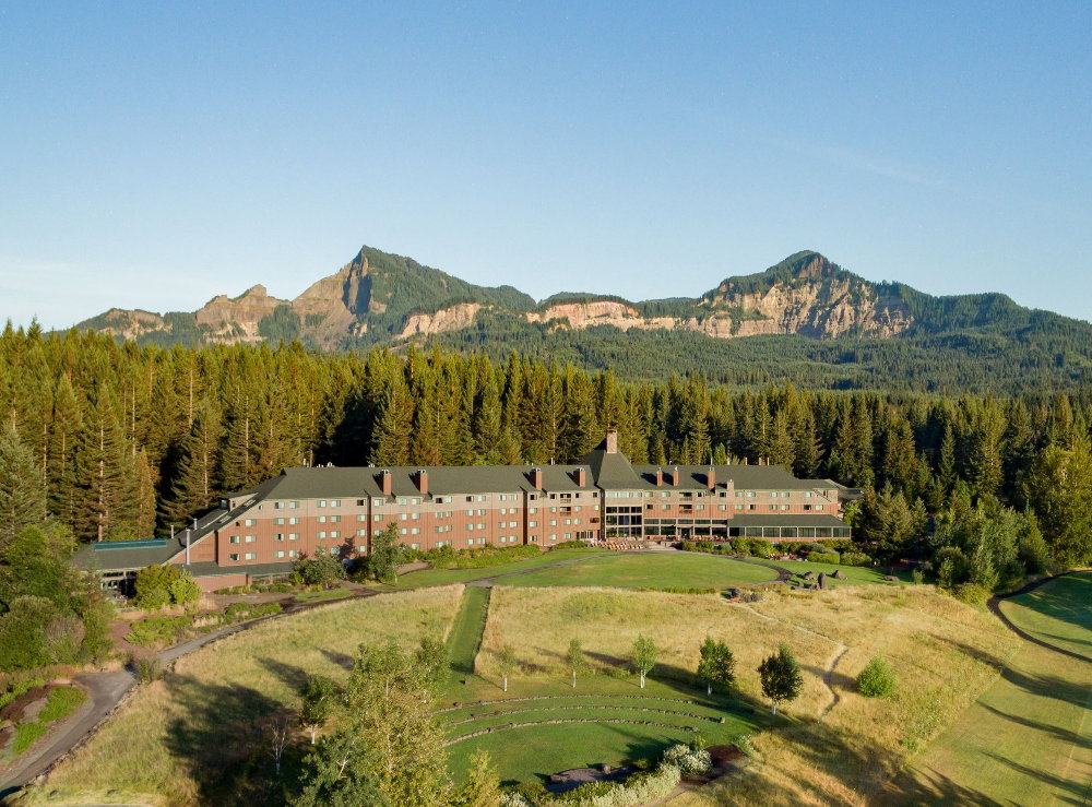 Aerial view of Skamania Lodge with forest and mountain backdrop. April 8, 2025