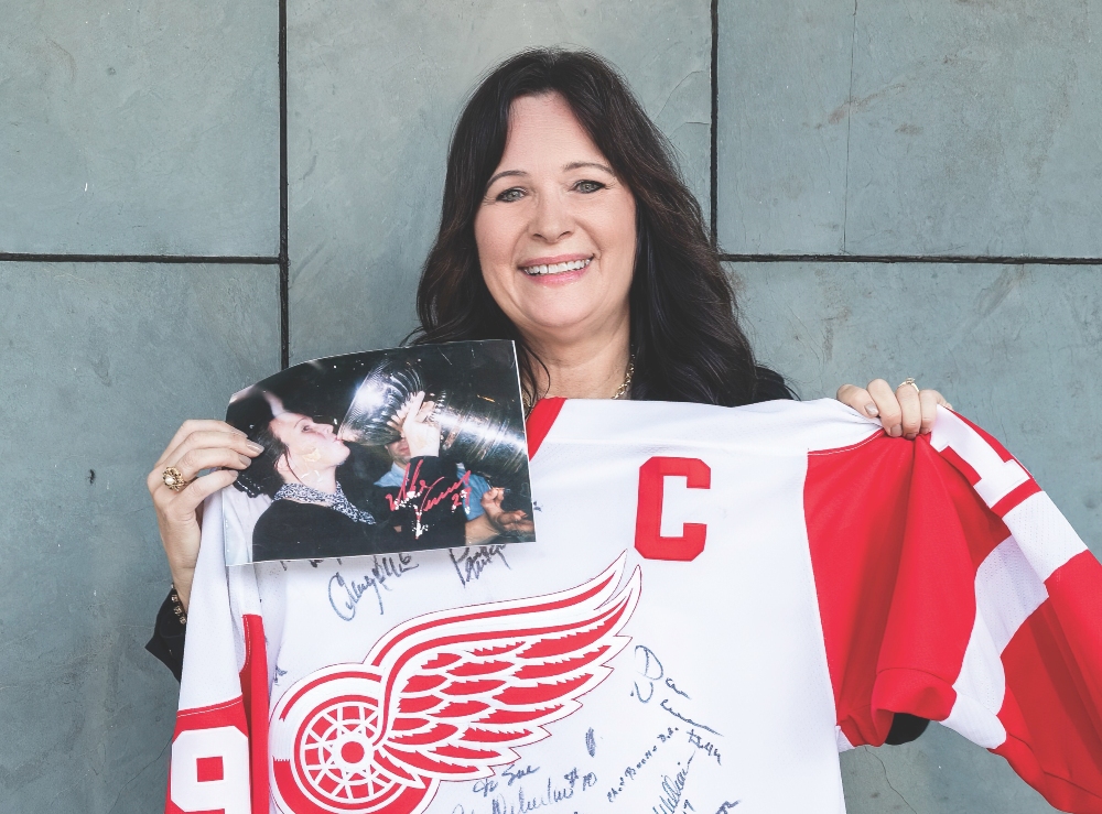 Sue Keels and her signed Red Wings jersey