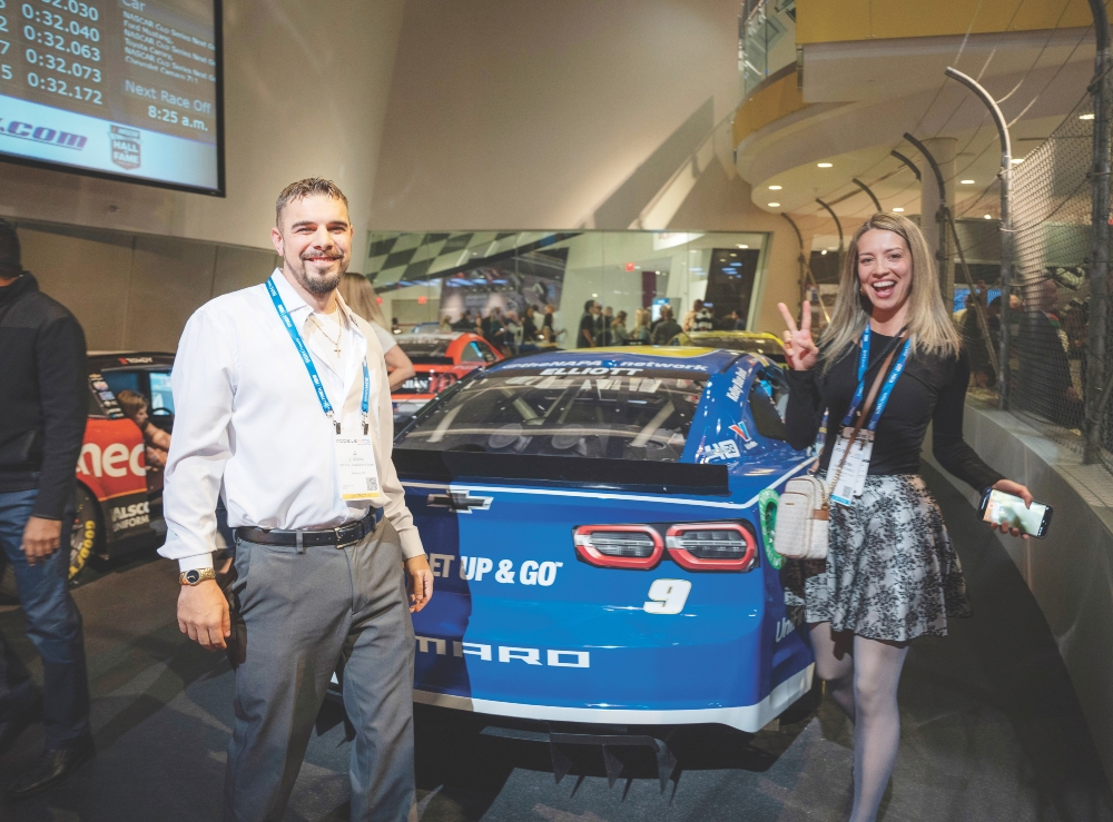 Attendees near racing simulators at the unconventional venue NASCAR Hall of Fame in Charlotte, North Carolina