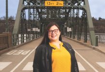 Kelly Nygaard of Discover Stillwater Adores Her Work 4.24.26 Kelly Nygaard of Discover Stillwater in front of the Stillwater Lift Bridge