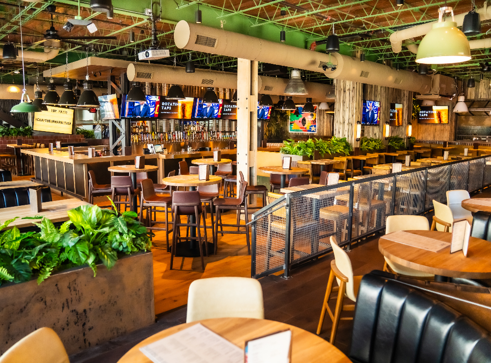 Main-floor lounge seating and bar area at Craft Beer Market in Dallas. April 16, 2026